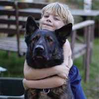 boy cuddling dog